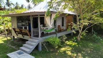 A house with a porch, a hammock, and a staircase leading to the entrance.