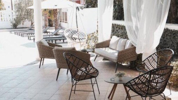 An outdoor seating area with wicker chairs and a sofa, a small round table, and a white canopy. - Hotel Orion Vodice (Vodice)