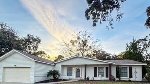 A single-story house with a garage, a front porch, and a small front yard.