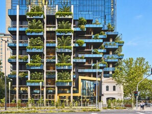 A modern high-rise building with multiple balconies, some with greenery. - Skyline Suites | Cosy Study Suite, Australia 108 (Southbank)