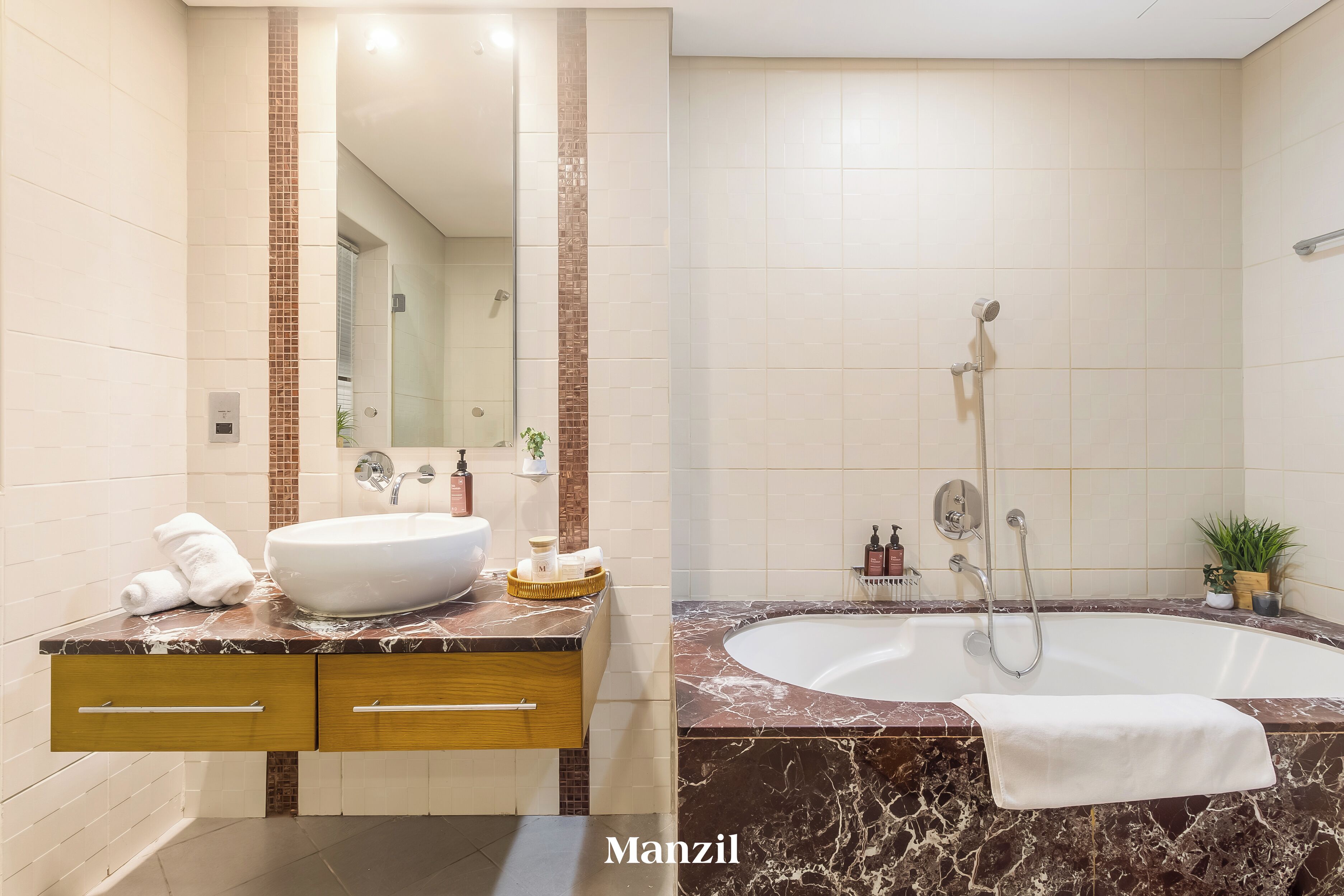 A modern bathroom with a large sink, a bathtub, and a mirror.