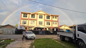 A multi-story building with a flat roof and a central entrance. - Zaru Hotel (Gizo)