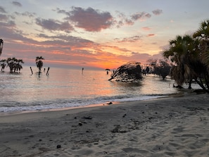 A beach with palm trees and a sunset. - Eliye Springs Resort (Eliye)