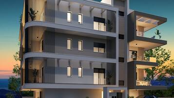 Un edificio moderno de varios pisos con balcones, ventanas amplias y techo plano.