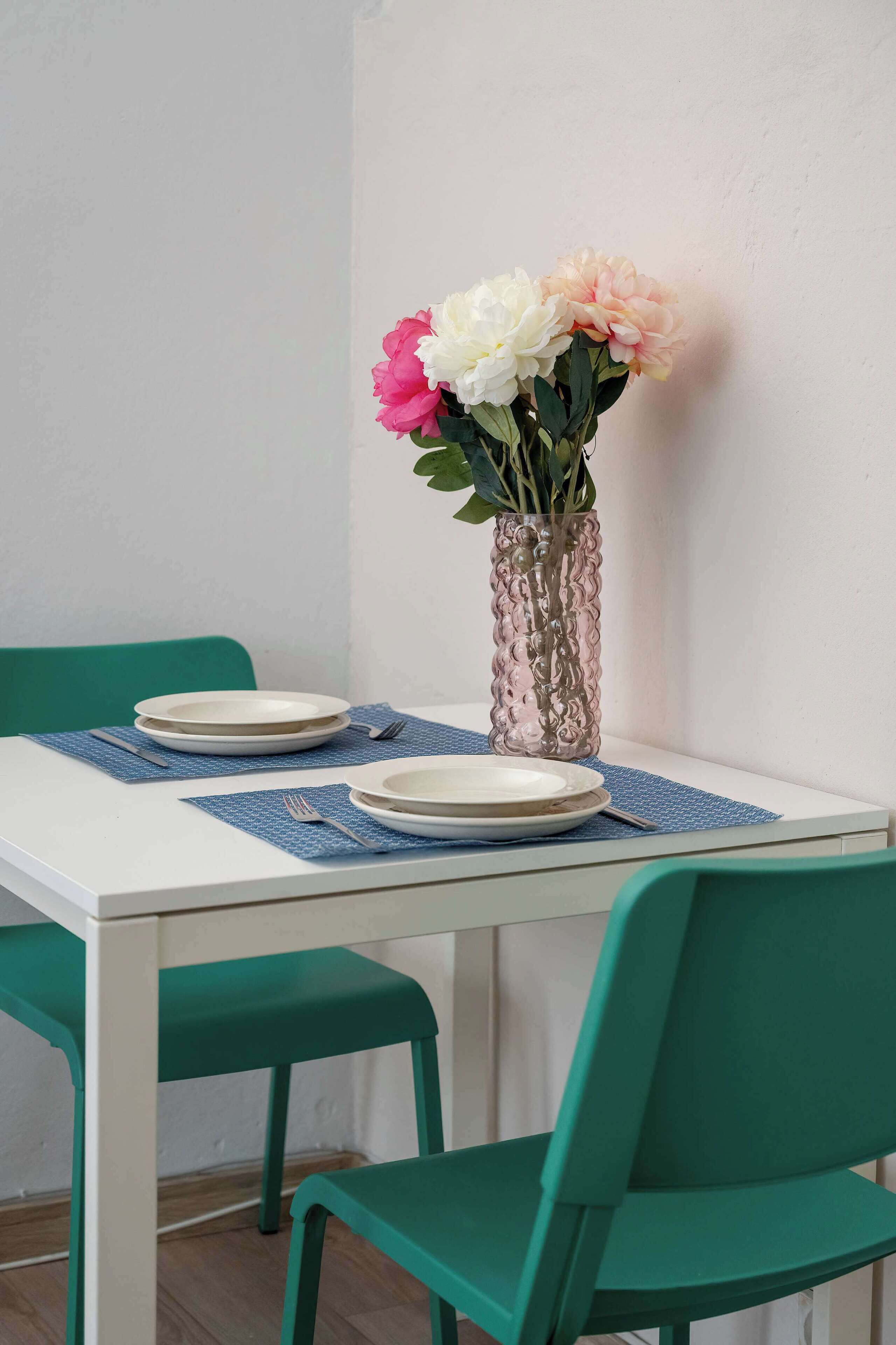Dining table with fresh flowers and place settings.