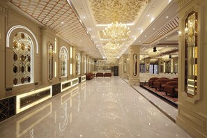 A spacious, well-lit hotel lobby with a polished marble floor, elegant chandeliers, and seating areas. - The Surya Golden Palace Pushkar (Pushkar)