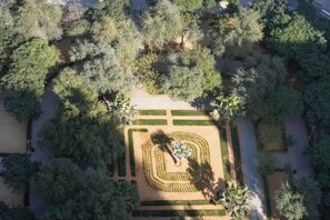 An aerial view of a park with a central circular garden, surrounded by trees and pathways. - Exclusive High-Floor Apartment  (Dubai)