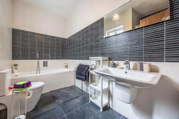 A modern bathroom with a toilet, bidet, bathtub, and a sink. - Modern Sunlit 2BR Penthouse Big Terrace (Msida)