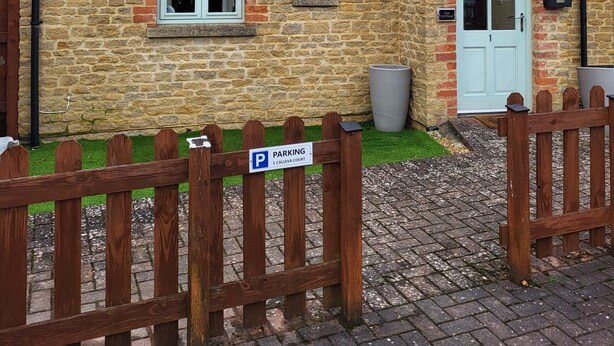 A stone house with a white door, a small window, and a satellite dish. -  Cosy warm cottage Cirencester,Capital of the Cotswolds,bibury close pet frendly (Cirencester)