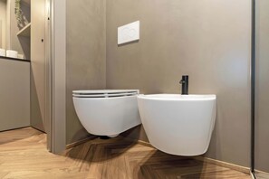 A modern bathroom with a toilet and a sink.