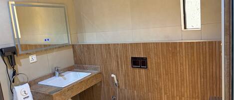 A bathroom with a sink, mirror, towel, and toilet.