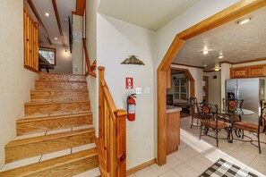 A staircase with wooden steps and a fire extinguisher on the wall. - The Blue Bear Cabin Lake Tahoe Family Getaway 2 Bedroom Home (South Lake Tahoe)