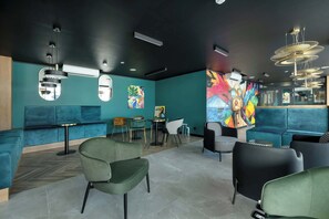 A modern interior with teal walls, a herringbone floor, and contemporary furniture. - Elegant Apartment | Rooftop Pool | Close to the Beach (Mielno)