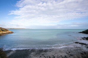 A coastal landscape with a beach, calm sea, and distant shoreline. - Rated Apartment Au Clos Du Loc'h, Private Terrace with No Overlook (Pordic)