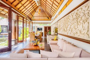 A spacious living area with a high ceiling, a dining area, and a kitchen. - Villa Jalamati - 3 BDR Luxury Escape, Prime Location (Kerobokan Kelod, Kec. Kuta Utara, Kabupaten Badung)