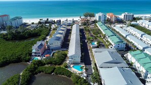 A coastal resort with multiple-story buildings, a central road, and a beachfront. - Bayview Villas 120 (Indian Shores)