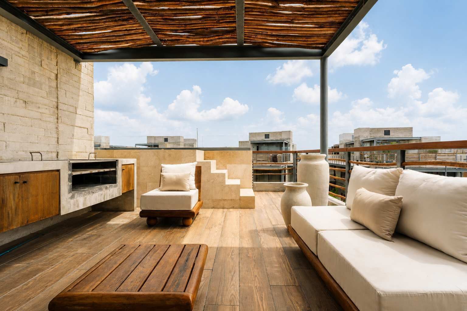 Eine Dachterrasse mit Holzterrasse, einer Couch, einem Sessel, einem kleinen Tisch und Grillplatz.