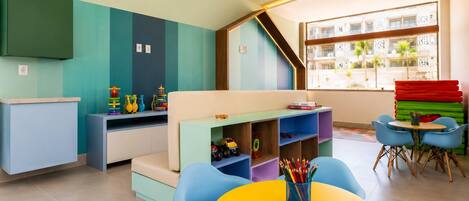 A children's play area with colorful furniture and toys.