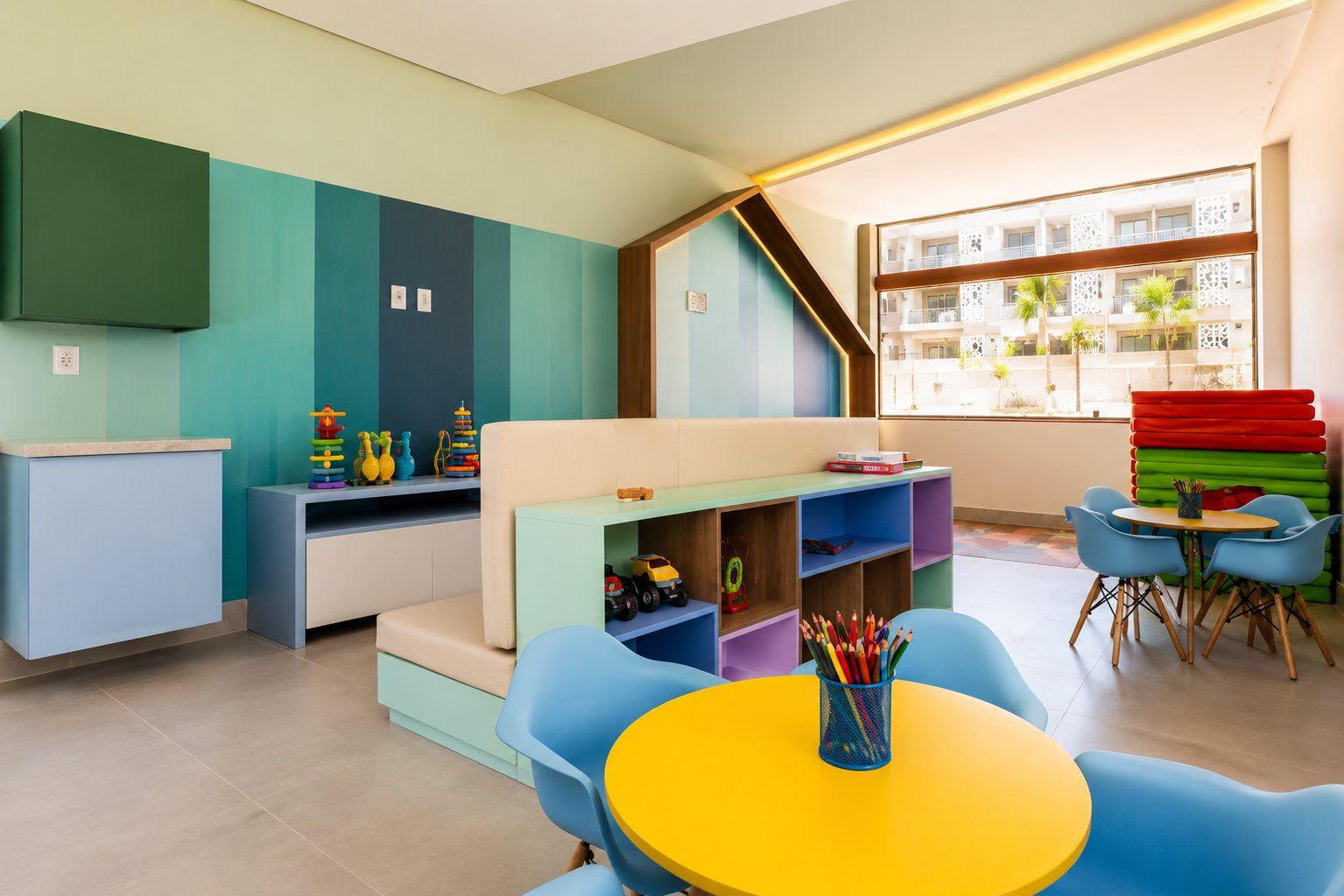 A children's play area with colorful furniture and toys.