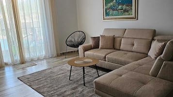 Departamento Deluxe, balcón, vista al mar | Área de sala de estar