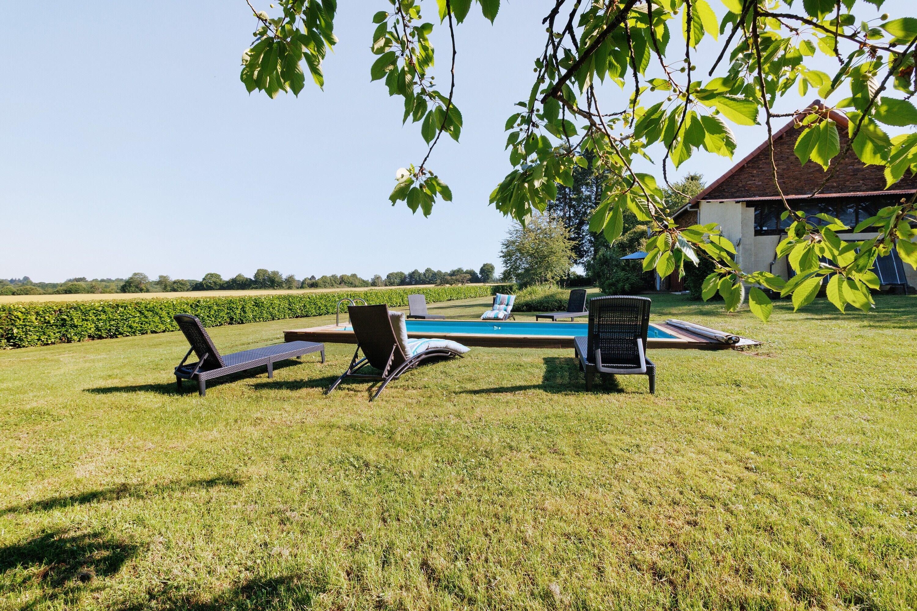 A poolside area with lounge chairs and a swimming pool.