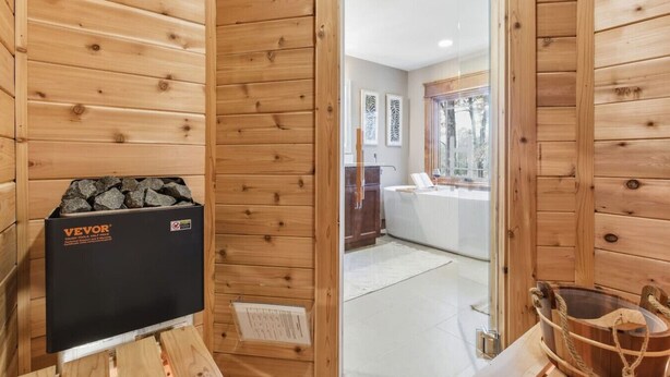A wooden cabin with a sauna, a wooden bench, and a sauna package labeled "VEVOR". - NEW Cabin on 3 Acres  W/ Hot Tub+Sauna - Sleeps 8 (Travelers Rest)