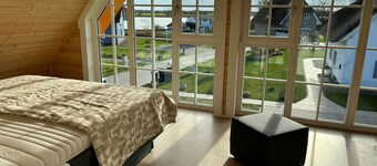 Wooden house with thatched roof at the harbor in Puddemin in a quiet location