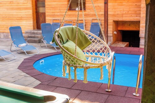 Wooden forest home with pool, fireplace and playground for kids