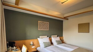 A hotel room with a bed, bedside tables, a chair, and a wall-mounted light fixture. - Hotel Zur Alten Schule (Pitten)