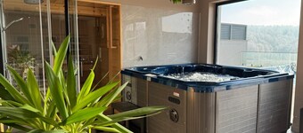 Modern villa with pool, jacuzzi, and sauna for relaxation and family getaway.