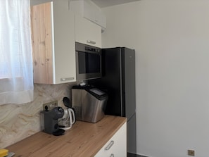 A kitchen with a built-in oven, a coffee maker, and a refrigerator. - Modern villa with pool, jacuzzi, and sauna in Bilogora for family relaxation. (Maglenča)