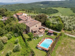 A large stone house with a swimming pool, surrounded by lush greenery and hills. - Holiday Home 'Casa Sogno Italiano Tuscany' with Stunning Views, Wi-Fi & AC (5-6 Guests) (Chianni)