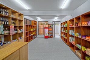 A clean, well-organized store with shelves stocked with various products, including beverages and household items. -  2-bedroom apartment  in Nyali/AC, 2 mins walk to the beach with Gym and pool. (Mombasa)