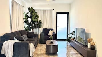 Superior Apartment, Balcony | Living area | 50-inch flat-screen TV with cable channels