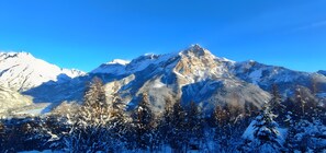 A snow-covered mountain with a clear sky.