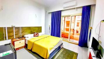 Economy Studio, Balcony, City View | Desk, laptop workspace, WiFi