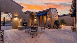 A patio with a fire pit, outdoor seating, and a view of the desert landscape. - Beautiful Gold Canyon home, Mt Views, Pool, Private setting (Gold Canyon)