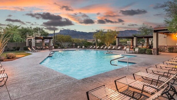 A rectangular pool with lounge chairs and a view of mountains in the background. - Beautiful Gold Canyon home, Mt Views, Pool, Private setting (Gold Canyon)