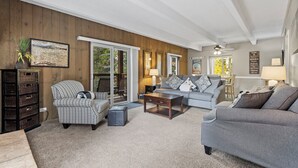 A spacious living room with a large window, a fireplace, and a cozy seating area. - Columbine #301 (Breckenridge)