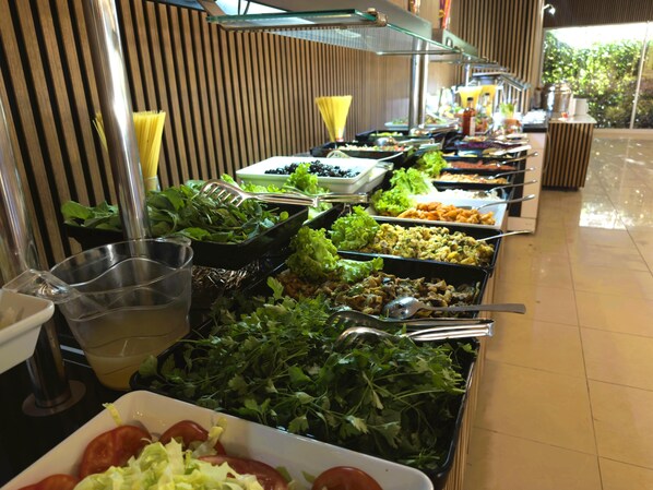 A buffet with various food options, including salads, vegetables, and other dishes. - Pera Aura Resort Hotel & Spa - All Inclusive (Kemer)