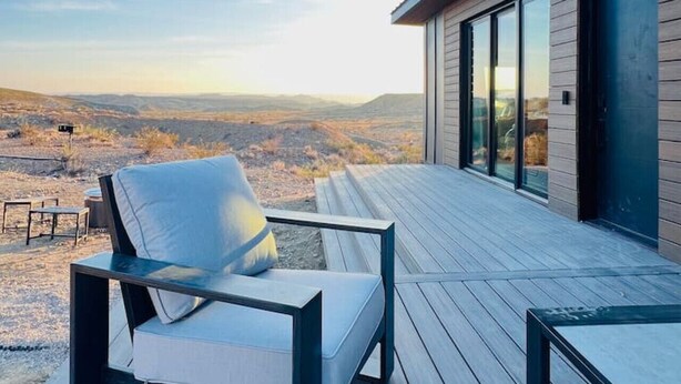 A modern outdoor deck with a view of a mountainous landscape. - Stellar Retreat at Big Bend - Cabin #3 (Terlingua)