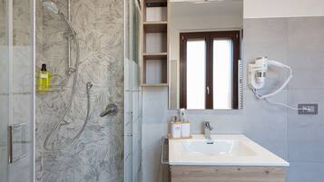 Regadera, secadora de cabello, bidet, toallas