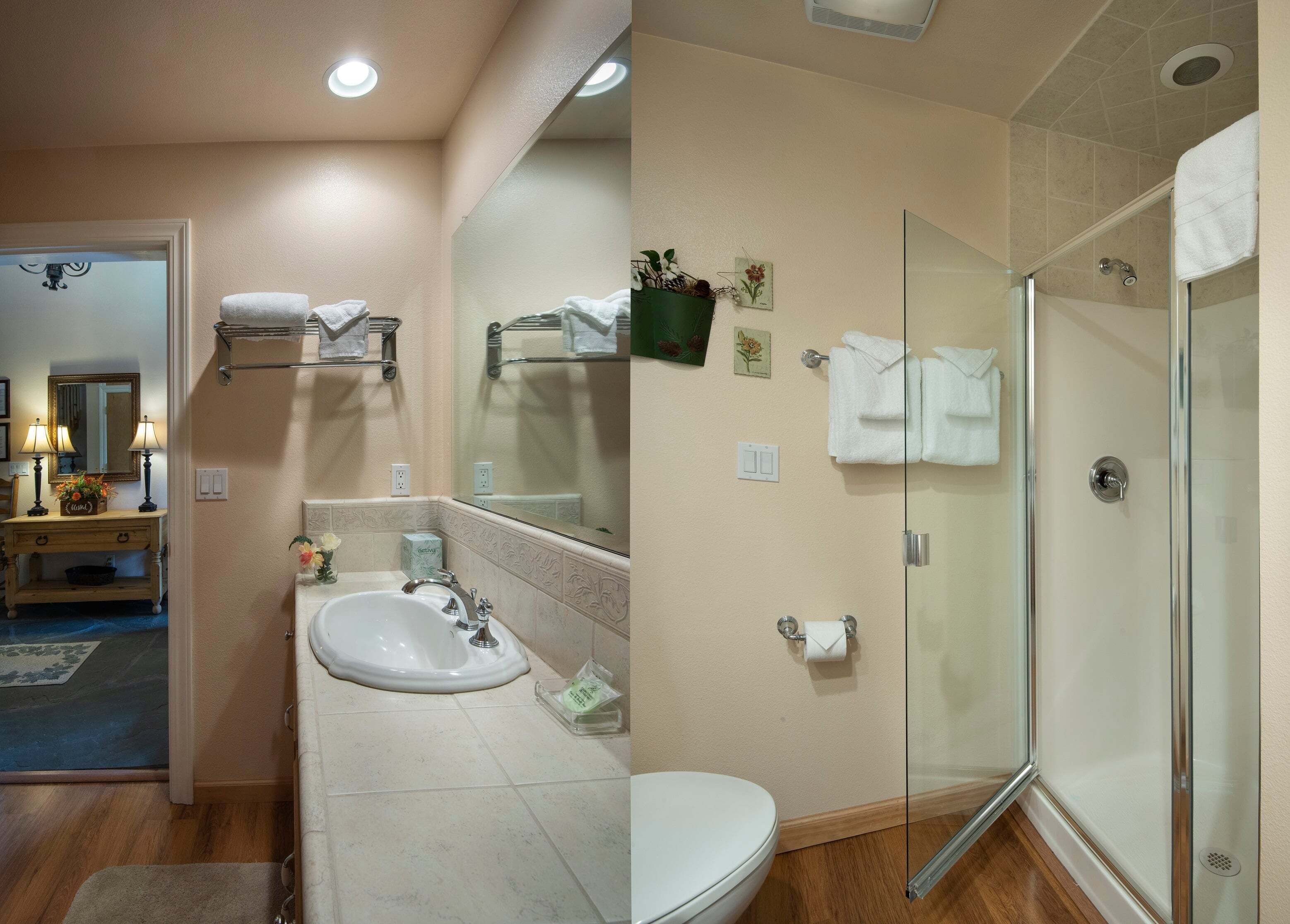 A bathroom with a sink, toilet, and glass shower enclosure.