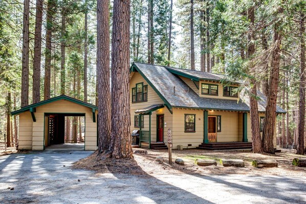 A lodge with a two-story structure, a covered porch, and a visible entrance. - Wawona Retreat (Yosemite National Park)