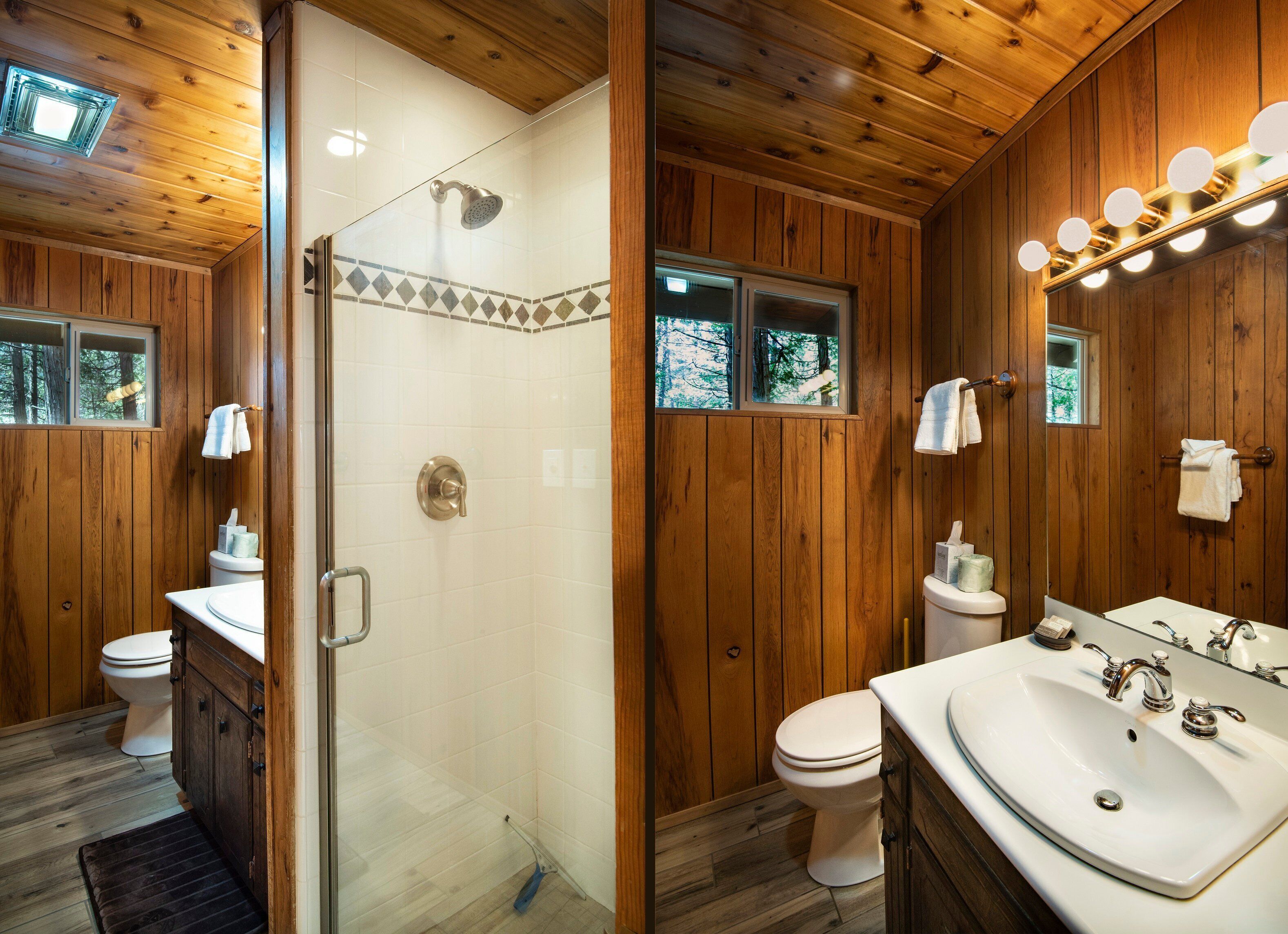 A wooden cabin bathroom with a shower, toilet, and sink.