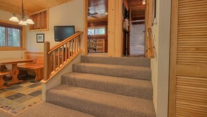 A wooden staircase with carpeted steps leading to a bedroom. - The Tree House (Yosemite National Park)
