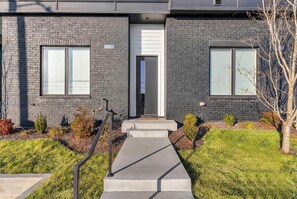 A modern two-story building with a brick facade, numbered 1339, featuring a concrete pathway leading to a door. - Nashville hot tub & game room house, sleeps 13 on VRBO (Nashville)