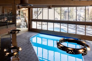 Indoor pool with floor-to-ceiling windows. - Premium Ski-in Suite with Balcony | 9 Hot Tubs (Breckenridge)