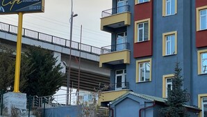 A multi-story building with balconies, a sign for 'KARM Life Konaklama', and a bridge in the background. - KARMİLİFE KONAKLAMA (Karaman)