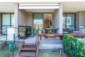 A modern building with a covered outdoor area, a staircase, and a view of the interior. - Beach Class Summer by Carpediem (Ipojuca)